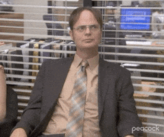 The Office gif. Rainn Wilson as Dwight Schrute sits in a chair in the office, moving his eyes uneasily from side to side, and says "Oh..."