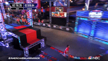 Reality TV gif. Drew Drechsel on American Ninja Warrior scampers up a steep ramp in an elaborate obstacle course. At the top he pumps his arm above his head in celebration. 
