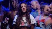 Music video gif. Noa Kirel in her music video for "Thought About That." She looks sexily at the camera while tilting her head slightly, ready to break out into a dance move.

