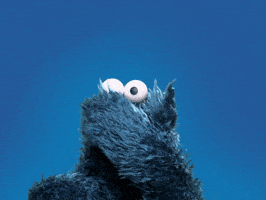 Sesame Street gif. Cookie Monster looks like a blue furry curtain and blows us a kiss.