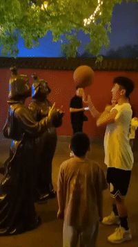 Statue Proves Perfect Partner for Basketball Trick
