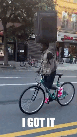 Brooklyn Cyclist Balances Suitcase on His Head