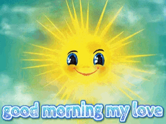 Digital illustration gif. Yellow sun with blue cartoon eyes and blushing cheeks sends out rays of yellow and green light against a blue cloudy backdrop. Text, "Good morning my love."