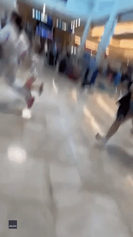 Chaotic Scenes at Cancun International Airport After Falling Signs Spark Panic