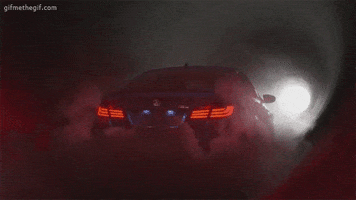Ad gif. Metallic blue BMW M5 stands alone in a dark tunnel with a hint of light at the end. Wisps of smoke obscure the back of the car, but its bright red tail lights glow brightly.