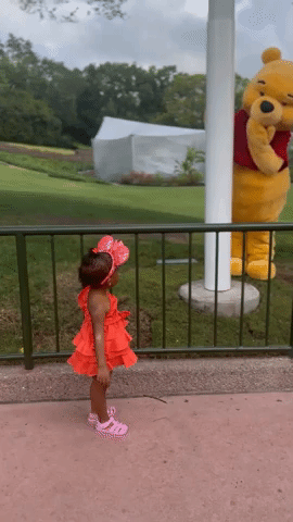Winnie the Pooh and Child Greet Each Other
