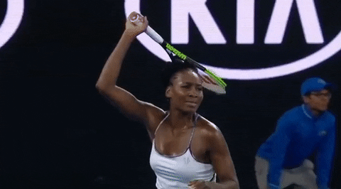 Sports gif. In slow motion, Venus Williams closes her eyes and scrunches up her face in exasperated frustration while roughly bringing down her racket to her side.