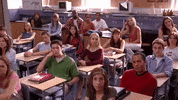 Movie gif. Rachel McAdams as Regina George in Mean Girls receives applause from her classmates. 