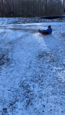 Kid on Sled Does Disappearing Act Under Pickup Truck