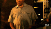Video gif. Two sweaty, muscular arms, one wearing a workout glove and the other covered with dark tattoos, grip each other tightly by the elbow before we jump cut to them grasping each other's hand and sharing a definitive fist bump.
