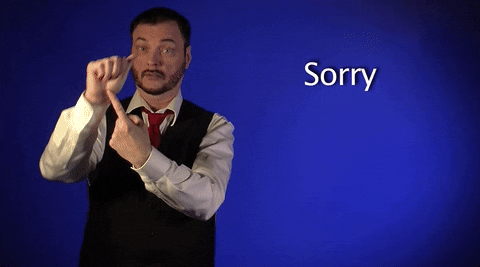 Video gif. A clip from Sign with Robert, showing how to say "sorry" in American Sign Language. He holds up his hand in a fist and points to his palm, then brings the fist to the center of his chest and makes a tight circle with it.
