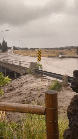 Motorists Drive Over Flooded Bridge in Hawaii