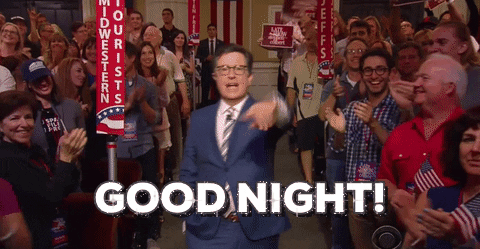TV gif. Stephen Colbert stands and waves goodbye, then turns away and jogs up through the aisle of an audience full of people clapping, waving American flags, and carrying banners. Text, "Good night!"
