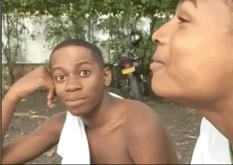Video gif. A young man reacts with shock. He backs up with his eyes wide.