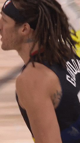 Sports gif. DeAndre Jordan of the Denver Nuggets is being carried by his teammates and has a blown away look on his face. 