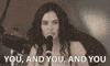 Celebrity gif. Singer is crooning onstage as she stares out into the audience, pointing at certain people while singing her lyrics of, "You, and you, and you."