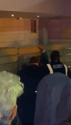 Man Surrounded by Security