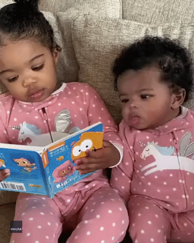 Little Girl Takes a Page Out of Mom's Book and 'Reads' to Younger Sister