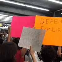Demonstrators Gather at La Guardia Airport to Greet Arriving Migrant Children