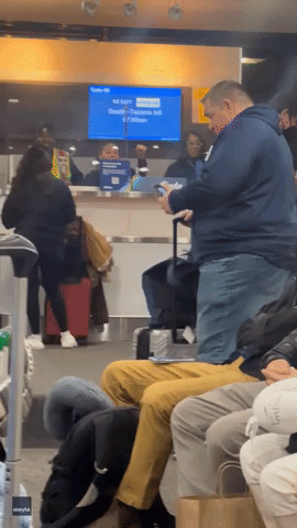 Alaska Airlines Counter Clerk Entertains Passengers With Trivia at Newark Airport