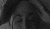 Video gif. Woman is lying in bed wearing a headband pulls it down over her eyes, revealing the message "let me sleep."
