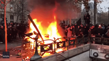 Pension Protesters Sing La Marseillaise as Fire Burns in Central Paris