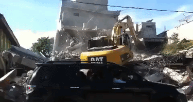 Bulldozer Digs Through Rubble After Aceh Quake
