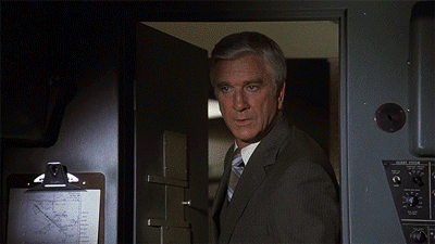 Movie gif. Leslie Nielsen as Dr. Rumack in Airplane steps into a cockpit and speaks to people inside. Text, "I just want to tell you all good luck. We're all counting on you."