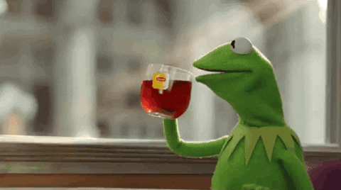 Video gif. Kermit the Frog, sitting in front of a brightly lit window, happily sips a cup of hot Lipton out of a clear mug. He takes a sip, then mouths, "Ahhhh." Now that's the tea.