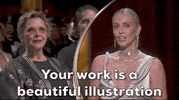 Oscars 2024 GIF. Split screen of Charlieze Theron saying, "Your work is a beautiful illustration of how to navigate the waves" to Annette Benning, who sits upright in the crowd.