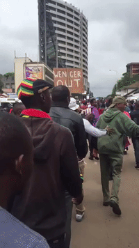 'Wenger Out' Sign Spotted Amid Protests Against Robert Mugabe