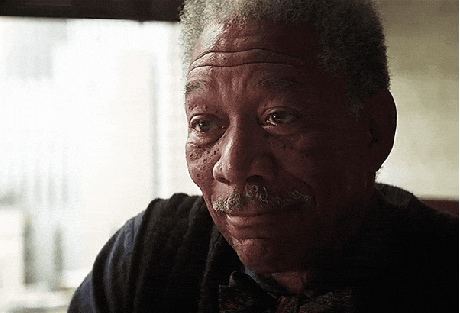 Celebrity gif. Actor Morgan Freeman as Lucius Fox in Batman The Dark Knight cocks his head to the side with an amused grin and cheerfully says Good luck! Text, Good luck!