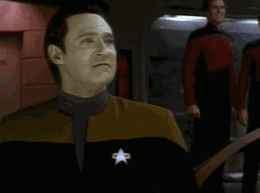 TV gif. Brent Spiner as Data on Star Trek: The Next Generation pumps his fist in celebration, saying, "Yes!"