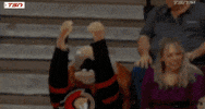 Video gif. Person wearing a Spartacat costume, the mascot of the Ottawa Senators, throws its head back and covers its face, reaching its arms up in the air like, "Why?!'