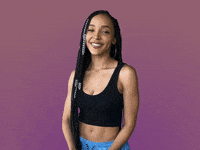 Celebrity gif. Tinashe looks touched as she puts her hands out towards us and says, "Thank you."