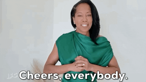Celebrity gif. Actress Regina King blows a kiss toward us with both hands and smiles, and says, “Cheers, everybody.”