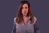 Celebrity gif. Chiara Sottile cringes innocently saying "oops," her hands jumping to her mouth to hide her incongruent smile.