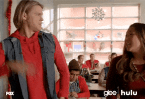 TV gif. Chord Overstreet as Sam Evans and Jenna Ushkowitz as Tina Cohen-Chang in Glee high five and clasp their hands together.