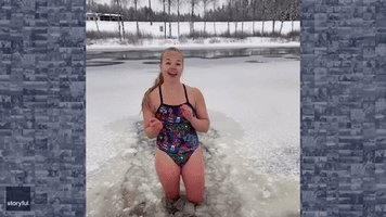 Girl Keeps Smiling as She Dances in Frozen River