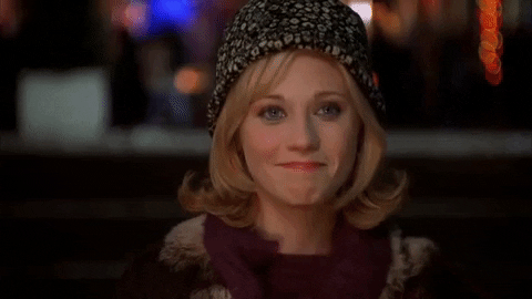 Movie gif. Zooey Deschanel as Jovie from Elf smiles and nods at us.