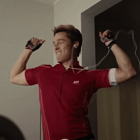 Movie gif. Brad Pitt as Chad in Burn After Reading listening to an iPod and dancing, pumping his arms, snapping his fingers, and biting his lip.