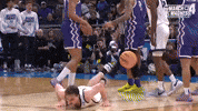 Sports gif. Isaac Johnson of the Utah State Aggies slides across the court on his stomach then sticks his tongue out with a grimace. Text, "He's a big fish!"