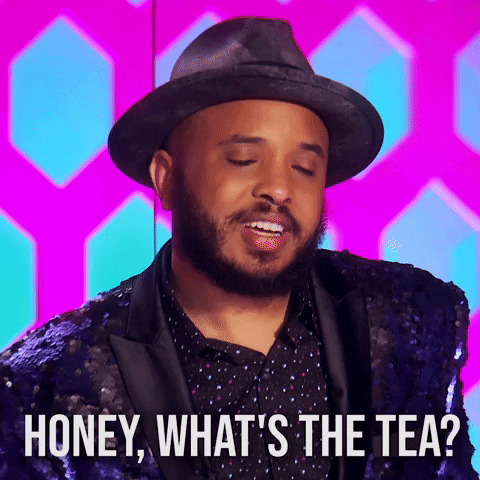 Reality TV gif. A judge on Rupaul’s Drag Race looks a drag queen up and down with a worried look on his face as he says, “honey, what’s the tea?”