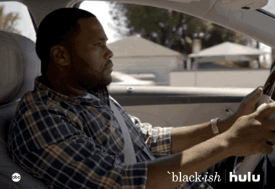TV gif. Anthony Anderson as Andre Johnson on Black-ish is driving and looking at the road. He then looks over at us with a worried look on his face and then nervously looks back at the road. 