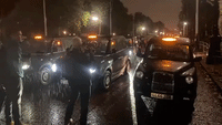 Black Cabs Line Up Outside Buckingham Palace in Tribute to Queen
