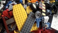 Man Performs Backflip Onto Pile of Lego
