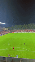Football Flies Out of Stadium Onto Balcony 
