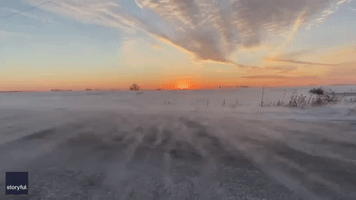 Thin Veils of Snow Blow Over Country Road During Wisconsin Sunset