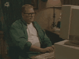 Celebrity gif. Drew Carey sits at an old blocky desk computer. He has his hands on the keyboard and then he shakily pulls his hands close to his face as he looks at the computer screen with fear.