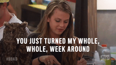 Reality TV gif. A woman on Big Brother sits at a table looking down as she uses a fork and knife to cut her food. Text, "You just turned my whole, whole, week around."